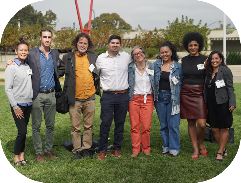 diverse group of people smiling for the camera